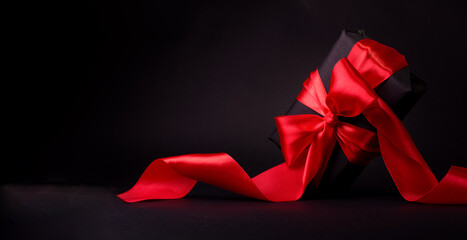 Black Friday Shopping Concept with Black gift box with red ribbon. Boxing day promo banner with...