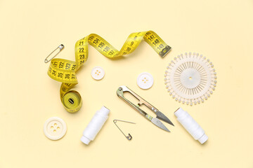 Set of sewing supplies on color background