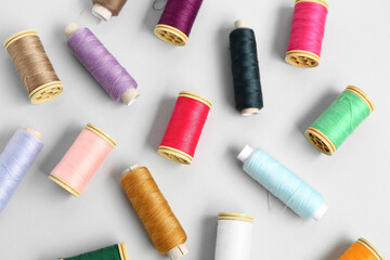 Many different thread spools on light background