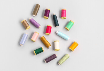 Many different thread spools on light background
