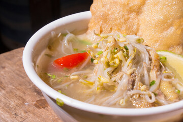 closeup, soto ayam or soto ayam in indonesia. Soto Ayam is a traditional Indonesian dish. made from vermicelli and the main ingredient is shredded chicken	