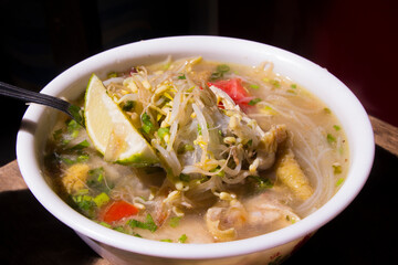 closeup, soto ayam or soto ayam in indonesia. Soto Ayam is a traditional Indonesian dish. made from vermicelli and the main ingredient is shredded chicken