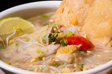 Soto lamongan, East Java, Indonesian soup with main ingredients of chicken, white noodles and fried onions. closeup