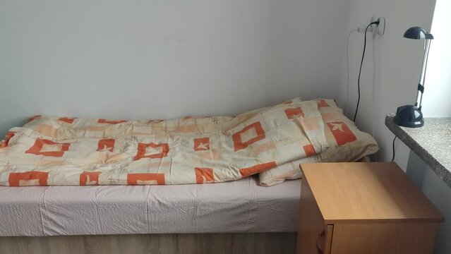 Bed in student room in campus. A room in the student hostel.