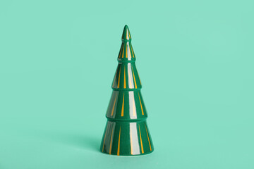 Beautiful ceramic Christmas tree on color background