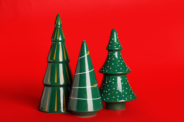 Beautiful ceramic Christmas trees on red background
