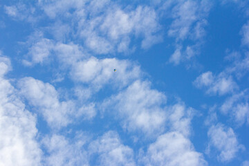 clouds in the sky and far far away a kite