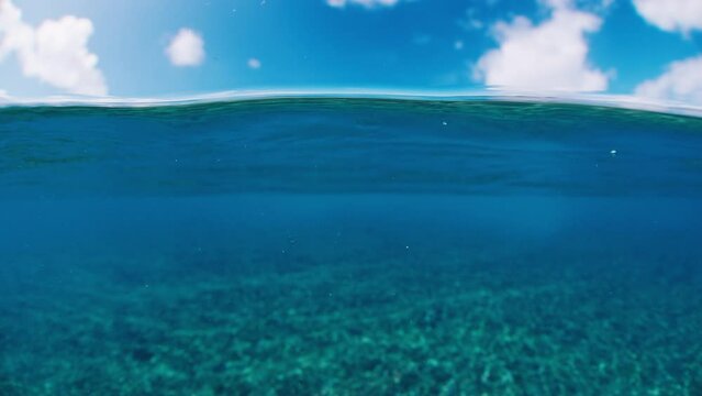 Splitted calm sea. Above and underwater view of the calm sea surface in the tropics
