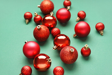 Red Christmas balls on green background, closeup