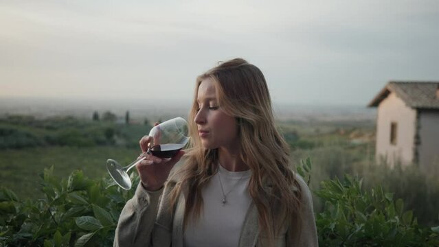 Beautiful Blond Woman Drinking Red Wine With Nature Background. Close Up