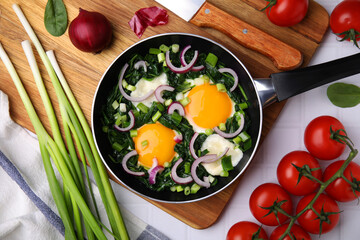 Flat lay composition with tasty Shakshouka and ingredients on white table