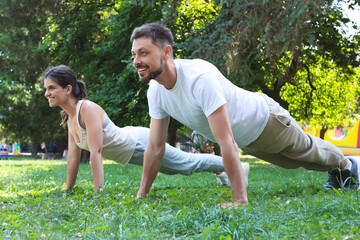 Man and woman doing morning exercise in park