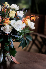 A bouquet of flowers with a bright accent on white roses
