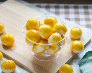A cup of Sweet Filling with Salted Egg on a wooden cutting board ready for eat.