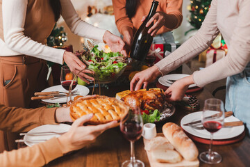 Group of young adult Asian Friends holiday party dinner at home around the table. Celebrate...
