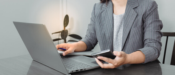 business woman looking the laptop or Notebook computer, personal working with laptop in the home office.