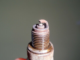 Used damage spark plug from motorcycle close up