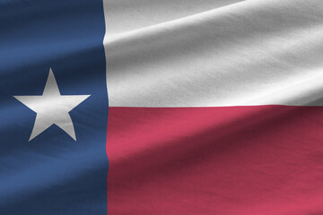 Texas US state flag with big folds waving close up under the studio light indoors. The official...