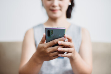 Women who operate mobile phones on sofas, smart phones