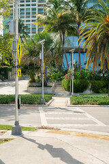 Crosswalk with yellow signs on the post at the side in Miami, Florida