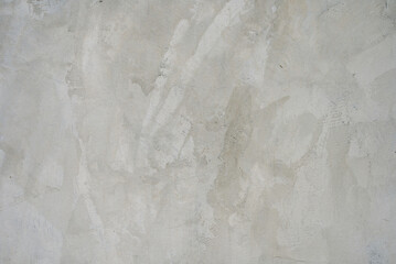 The cement flap surface has scratches, black and white stains, traces caused by plastering to create an artistic pattern