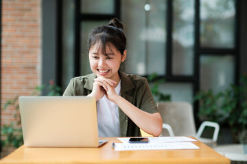 Young asian business woman or student working online on computer laptop.