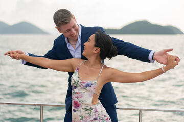 luxury relaxing couple traveler of cruise yacht with background of sea and white sky. Concept business travel. Cruise luxury travel lifestyle businessman and woman on vacation.