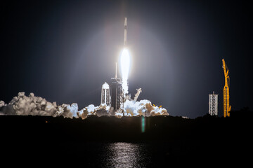 SpaceX rocket Falcon 9 rocket  capsule soars upward after lifting off from launch pad. Digitally enhanced. The elements of this image furnished by NASA. - Powered by Adobe