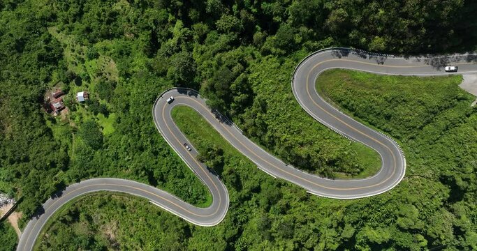 aerial view ROAD No.1081 beautiful curve winding mountain road between Pua District,Nan Province, Northern of Thailand is check-in point and landmark that tourist shooting photo,4k video aerial view,
