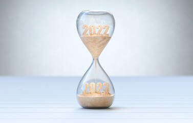 New Year 2023, The time of 2022 is running out in the hourglass.