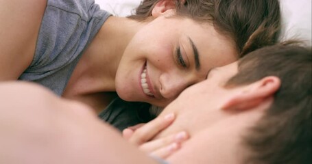 Couple kiss, erotic and sexual in bed, love and passion together with happy smile, care and intimate. Young man, woman and happiness with kissing, romance and sensual in bedroom and relationship