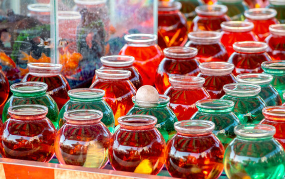 Goldfish game at a fair. toss a ball into a bowl and win a new fish pet