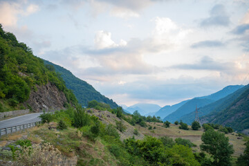 Fototapeta na wymiar gorge between mountains green bushes cloudy sky