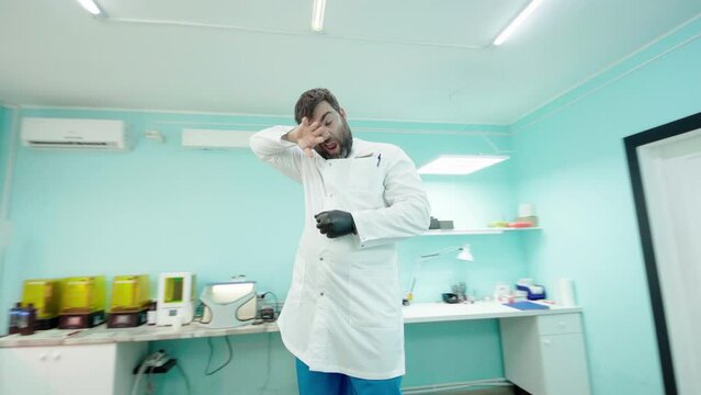 Emotional doctor dentist takes off gloves after working day. Video 360 degrees.