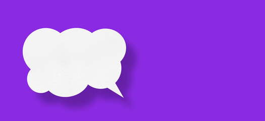 white cloud paper speech bubble shape against purple background