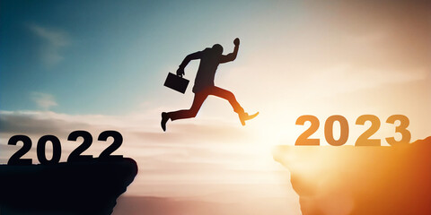 New year concept of 2023. New year's card. Silhouette of a man jumping over a cliff.businessman jumping to 2023, Happy new year concept.motivation, challenge, Business.