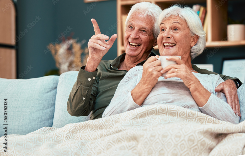 Wall mural Couple in retirement, elderly and watch television on couch at family home, relax with funny tv show or movie and excited with happiness and coffee. Retired, old man and old woman happy together.