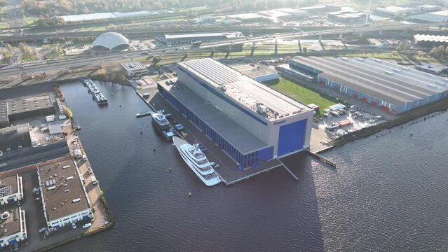 Amsterdam, 19th of November 2022, The Netherlands. Feadship vessel shipyard. Luxury superyacht builder and maintainance facility company. Aerial drone view.