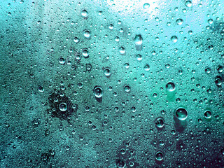 Beads of condensation on a pane of glass