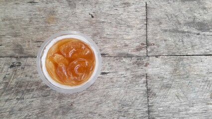 A cup of ice tea on the wooden table