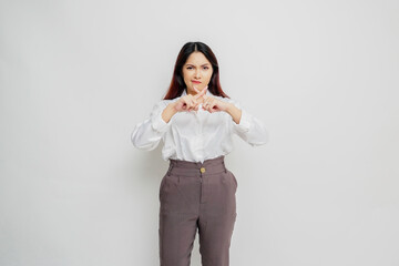 Beautiful Asian woman wearing white shirt with hand gesture pose rejection or prohibition with copy...