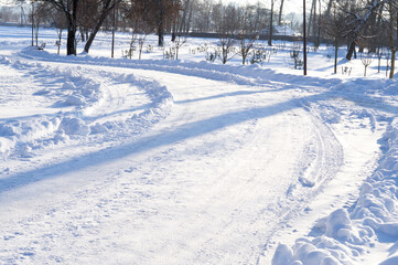 Winter. Road through the winter forest on a clear sunny day