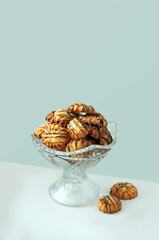 cookies with chocolate lies in a crystal vase on a blue background