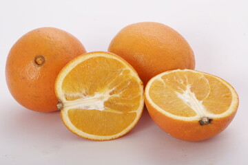 Fresh oranges, whole and sliced
