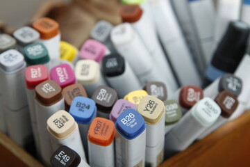 Closeup of artist markers with the names of colors written on the covers