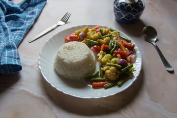 Indian lunch thali steamed rice and vegetables in a plate. Selective focus.