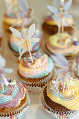 Paper toy ballet fairy decoration on many colourful muffin cakes