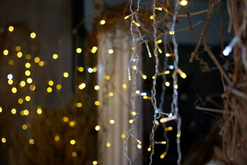 holiday, illumination and decoration concept - bokeh of christmas garland lights over grey background