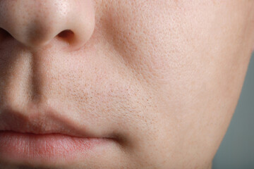 Closeup view of man with healthy skin on light grey background