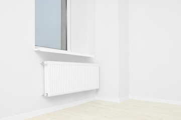 New empty office room with white walls, radiator and clean window. Interior design